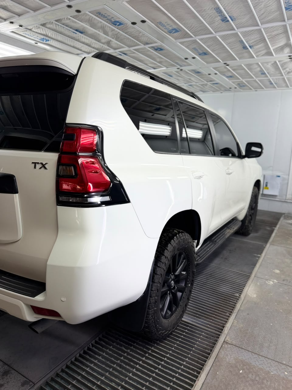 Detailing team preparing vehicle for ceramic coating